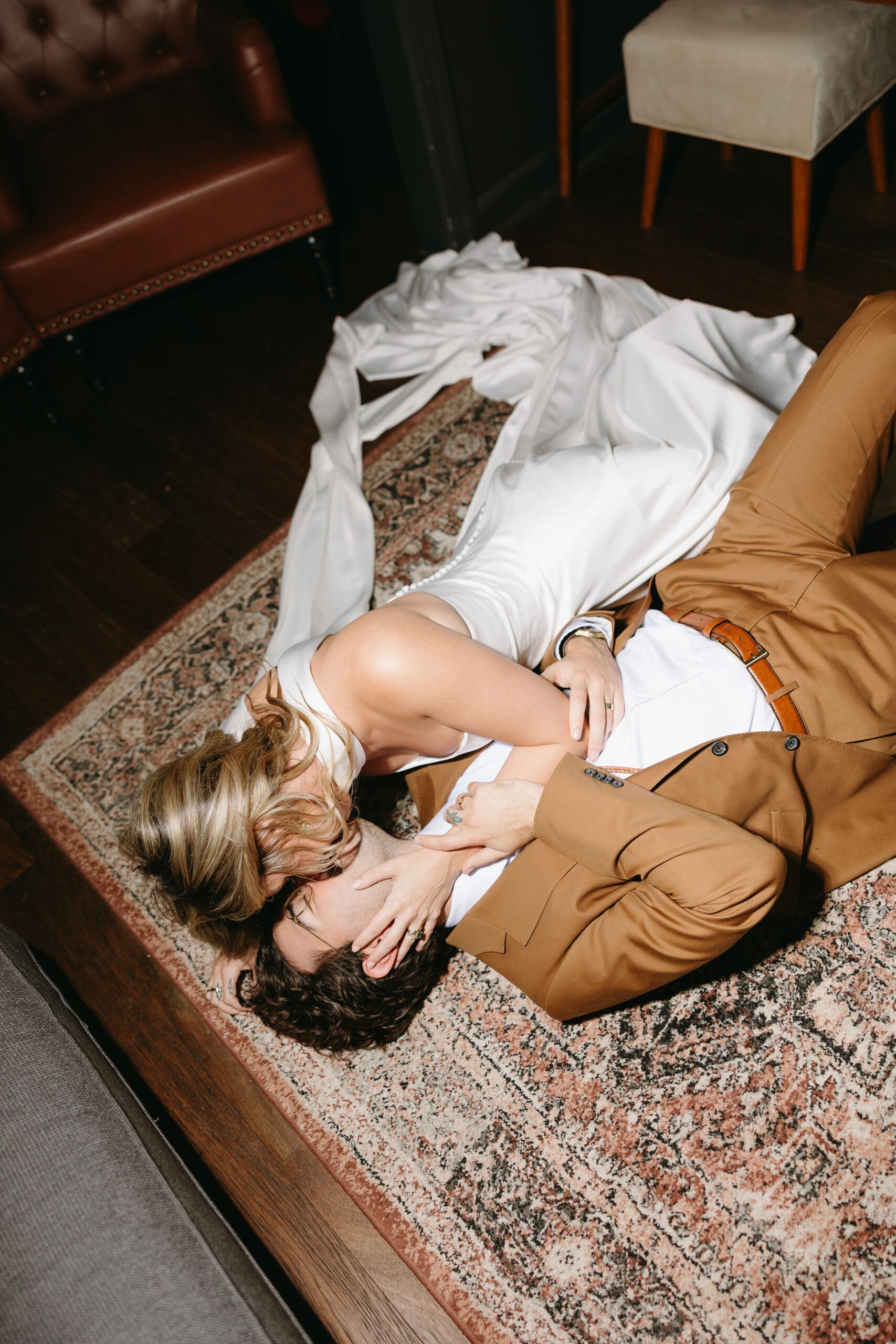 Couple lying on floor in wedding attire